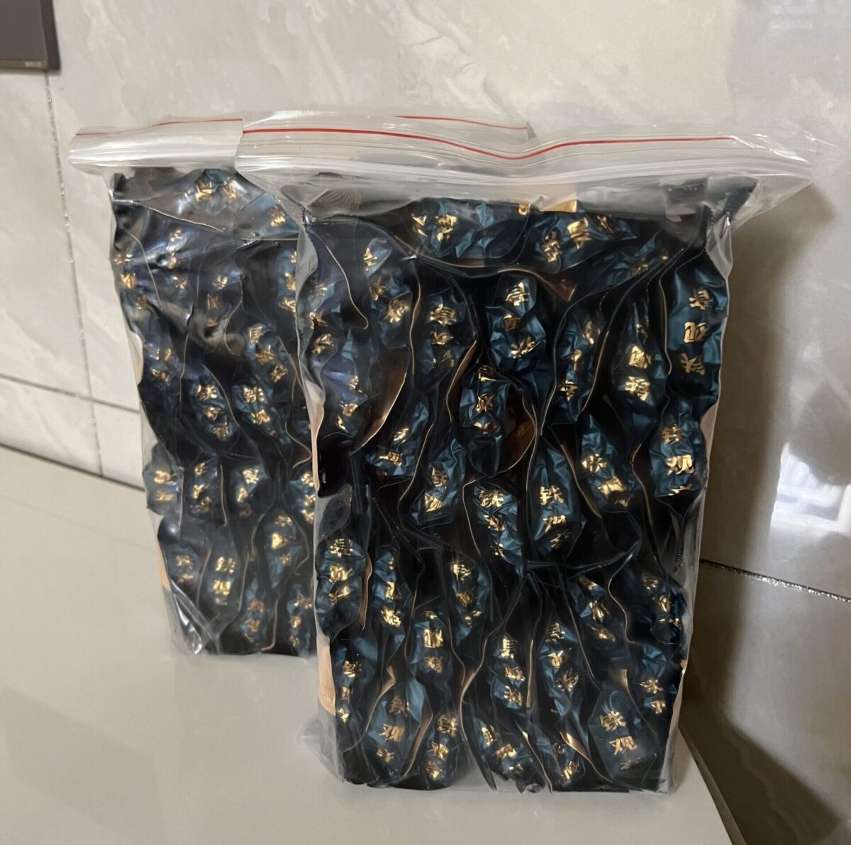 Premium Tieguanyin Oolong Tea leaves close-up, Brewed cup of Autumn Harvest Tieguanyin Oolong, Box of Tieguanyin Oolong Tea Sachets