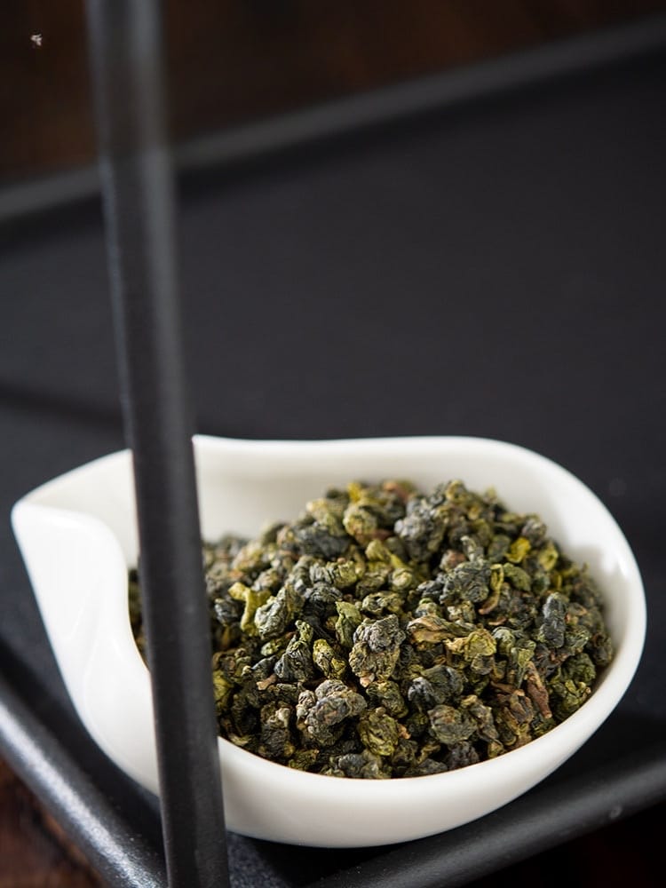 Jin Xuan Milk Oolong Tea loose leaves in a white bowl